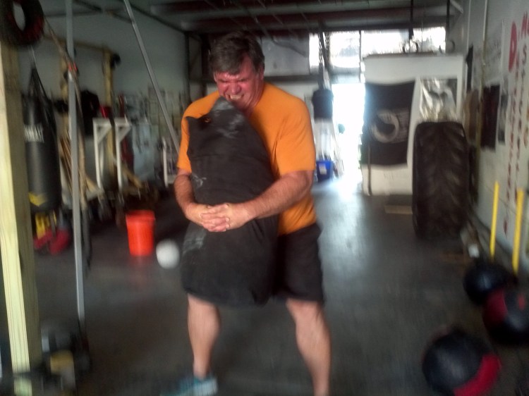 Sandbag bear-hug squats with 160lb